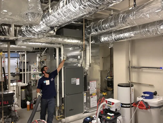 Abington Air Duct Cleaning specialist performing thorough furnace duct cleaning in a Abington residence