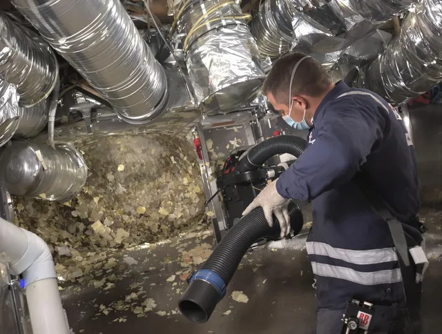 Abington Air Duct Cleaning specialist operating negative pressure cleaning equipment for thorough duct maintenance in Abington